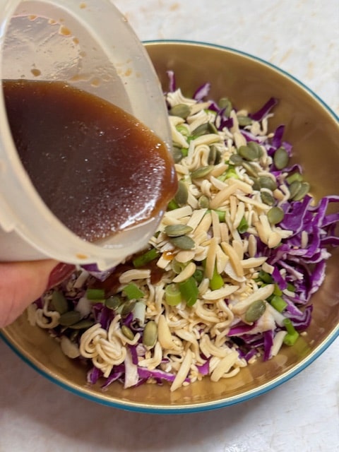 pour dressing onto salad