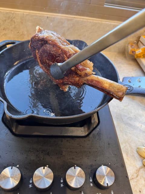 using the tongs to render the fat cap