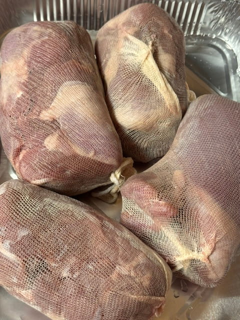 dark meat turkey rolls in cheesecloth netting